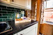Levisham Camping Coach kitchen area, with guest welcome tray.