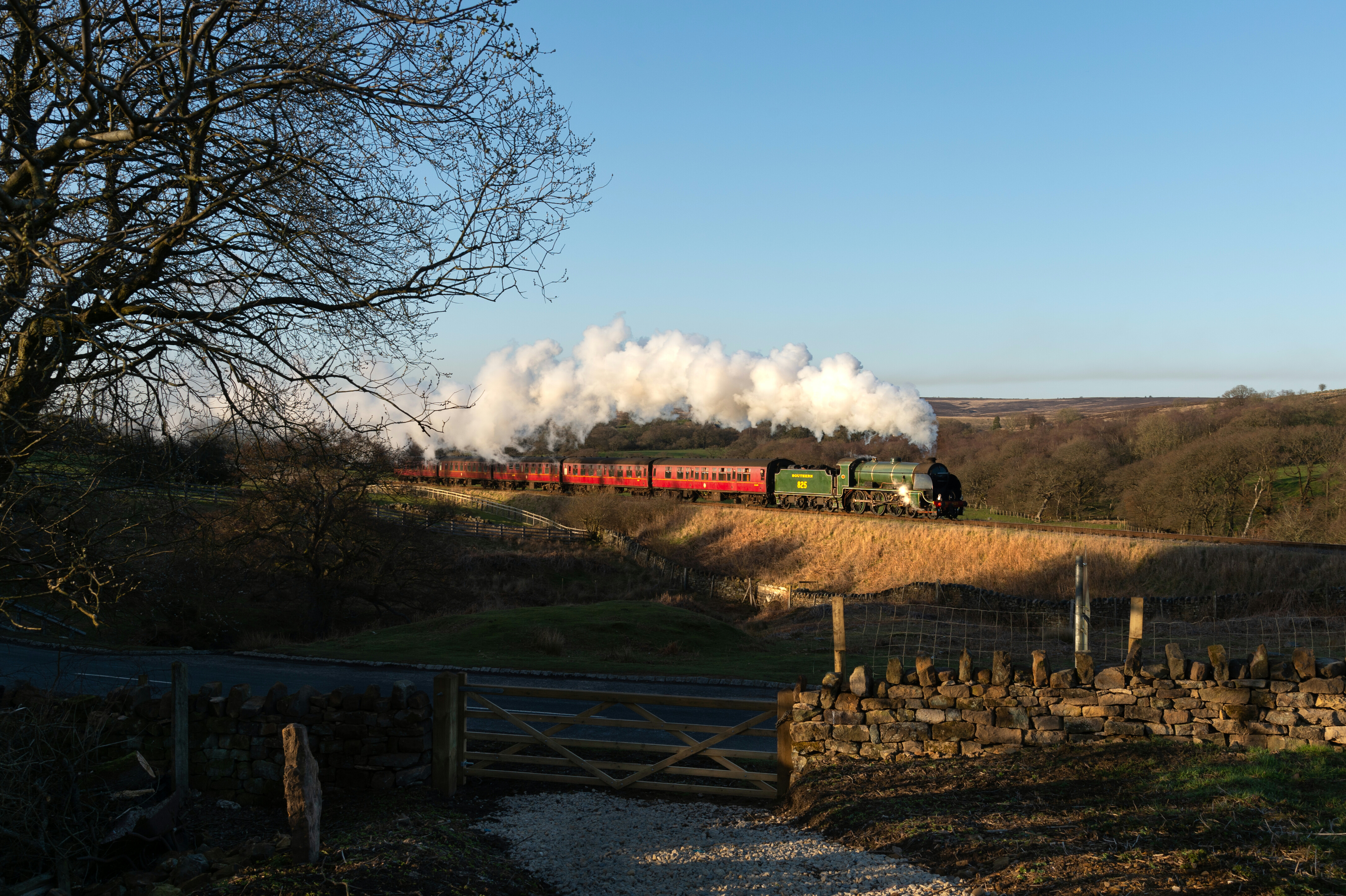 No. 825 is caught in the late afternoon sun near Moorgates on the NYMR heritage line.