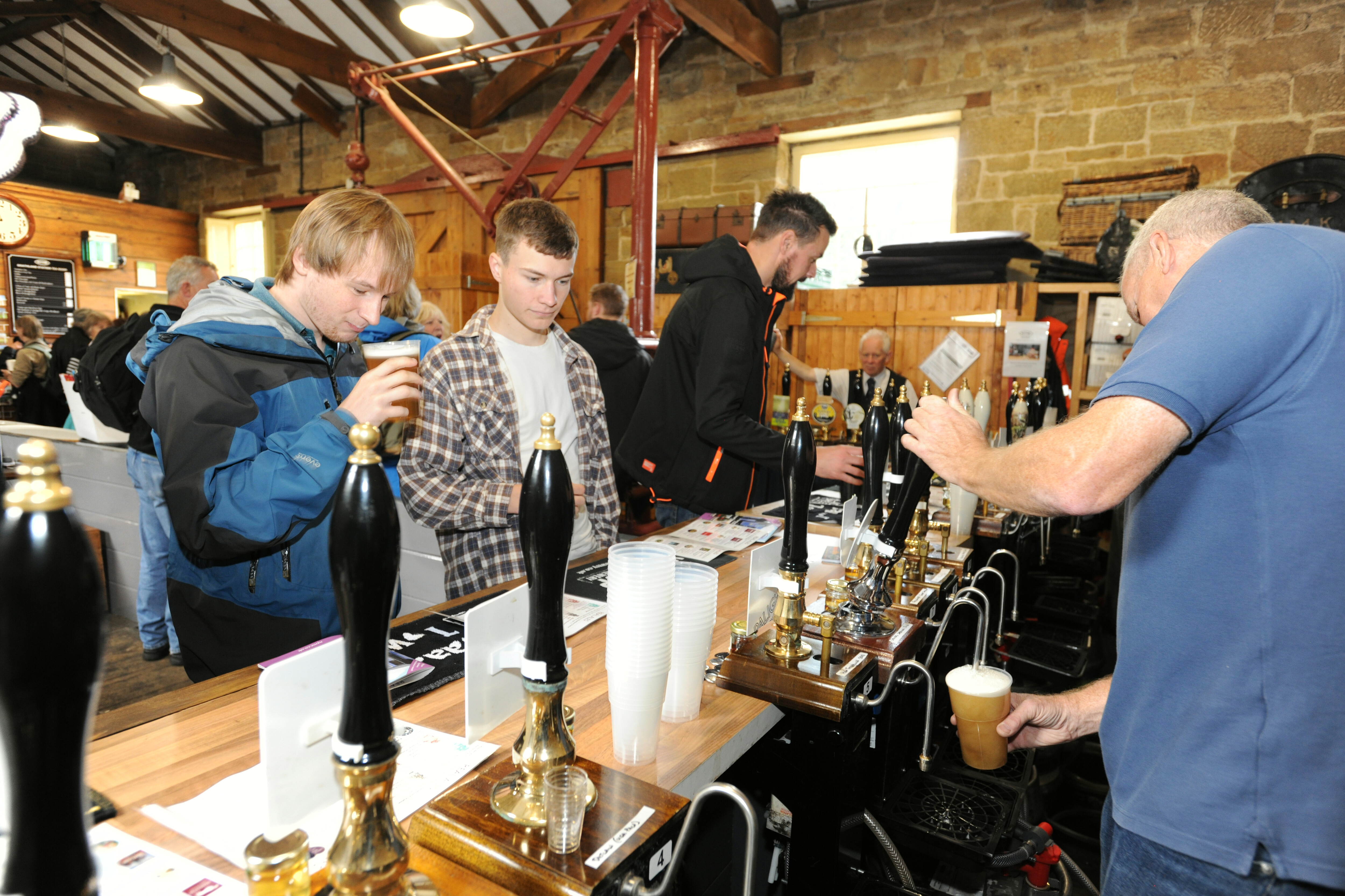 Goathland Beer Festival customers try a beer from the bar.