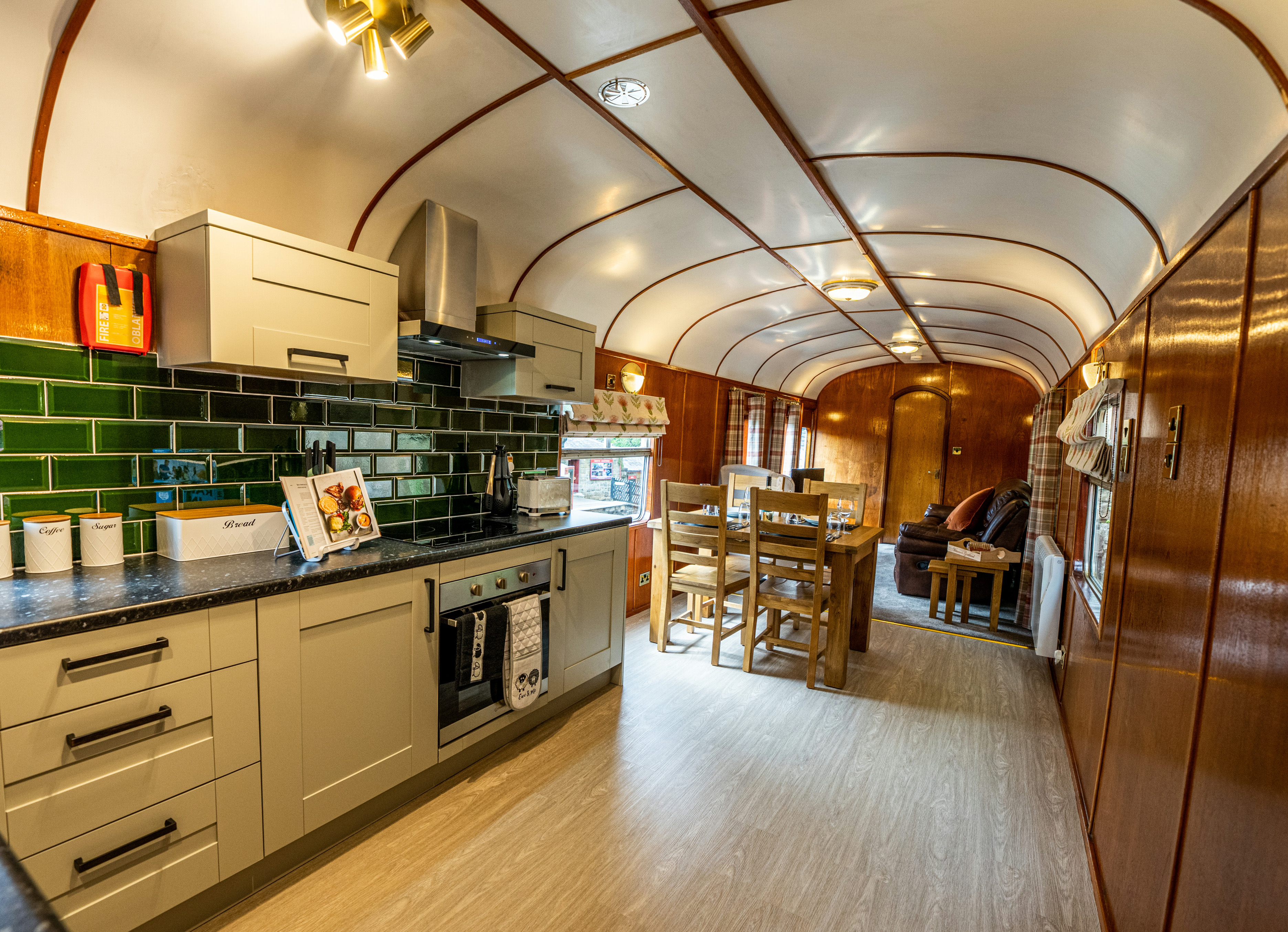 Goathland Camping Coach kitchen, with the living room in the background.