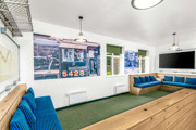 A room at The Outstation with blue upholstered wooden bench seats and a large poster of engine number 5428.