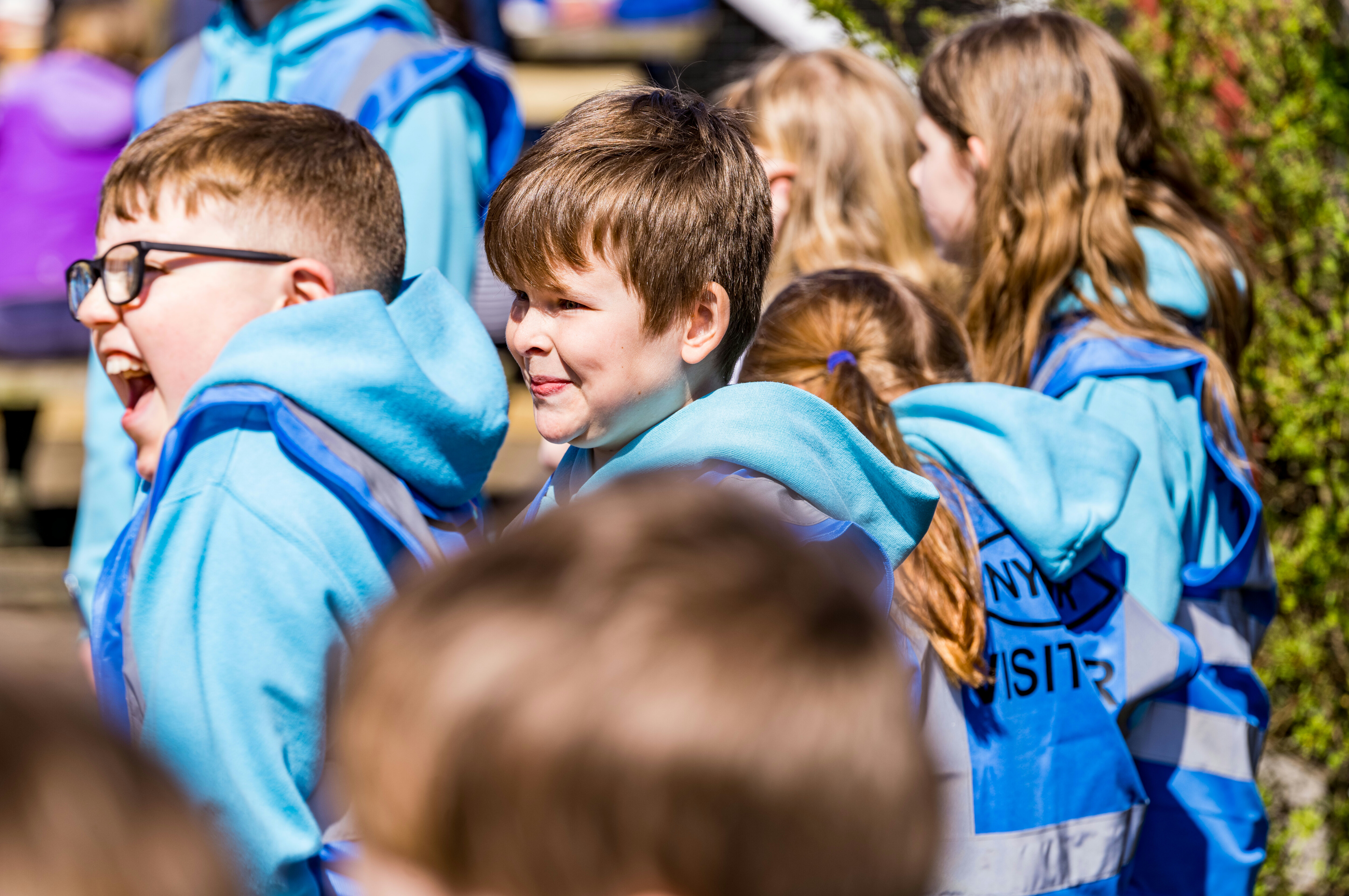 School children laugh and smile at Goathland Station.