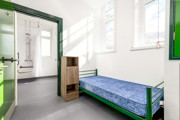 A single bedroom at The Outstation looking into an en suite wet room.
