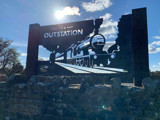 The Outstation sign which is a silhouette of a steam engine.