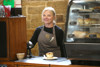 A tearoom assistant behind the counter at Goathland Warehouse Tearoom.