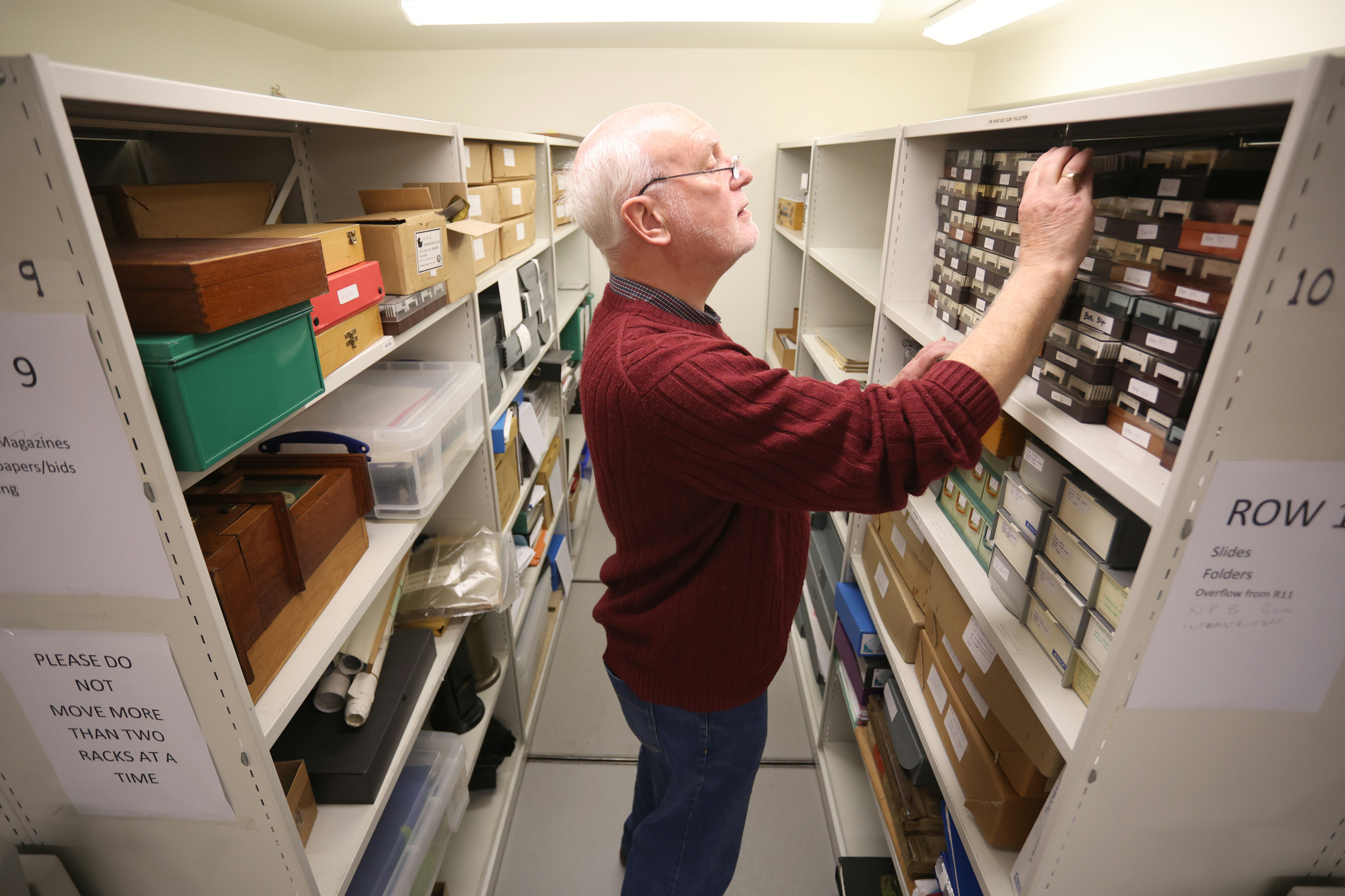 A volunteer looks through a selection of artefacts.