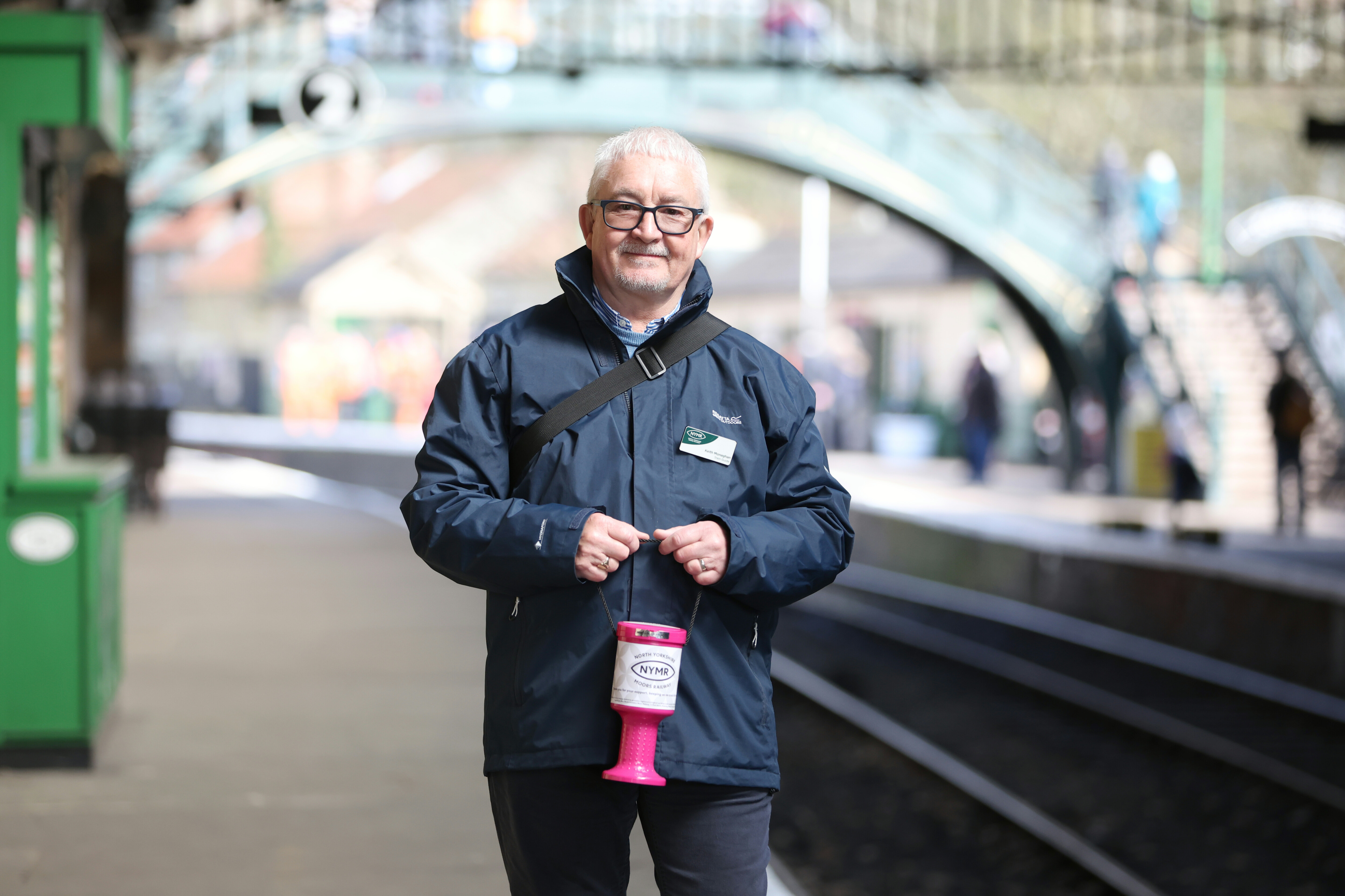A volunteer stands on the platform at Pickering Sattion.