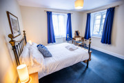 Grosmont Station House double bedroom with blue furnishings and a white duvet.