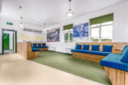 A room at The Outstation with blue upholstered wooden bench seats.