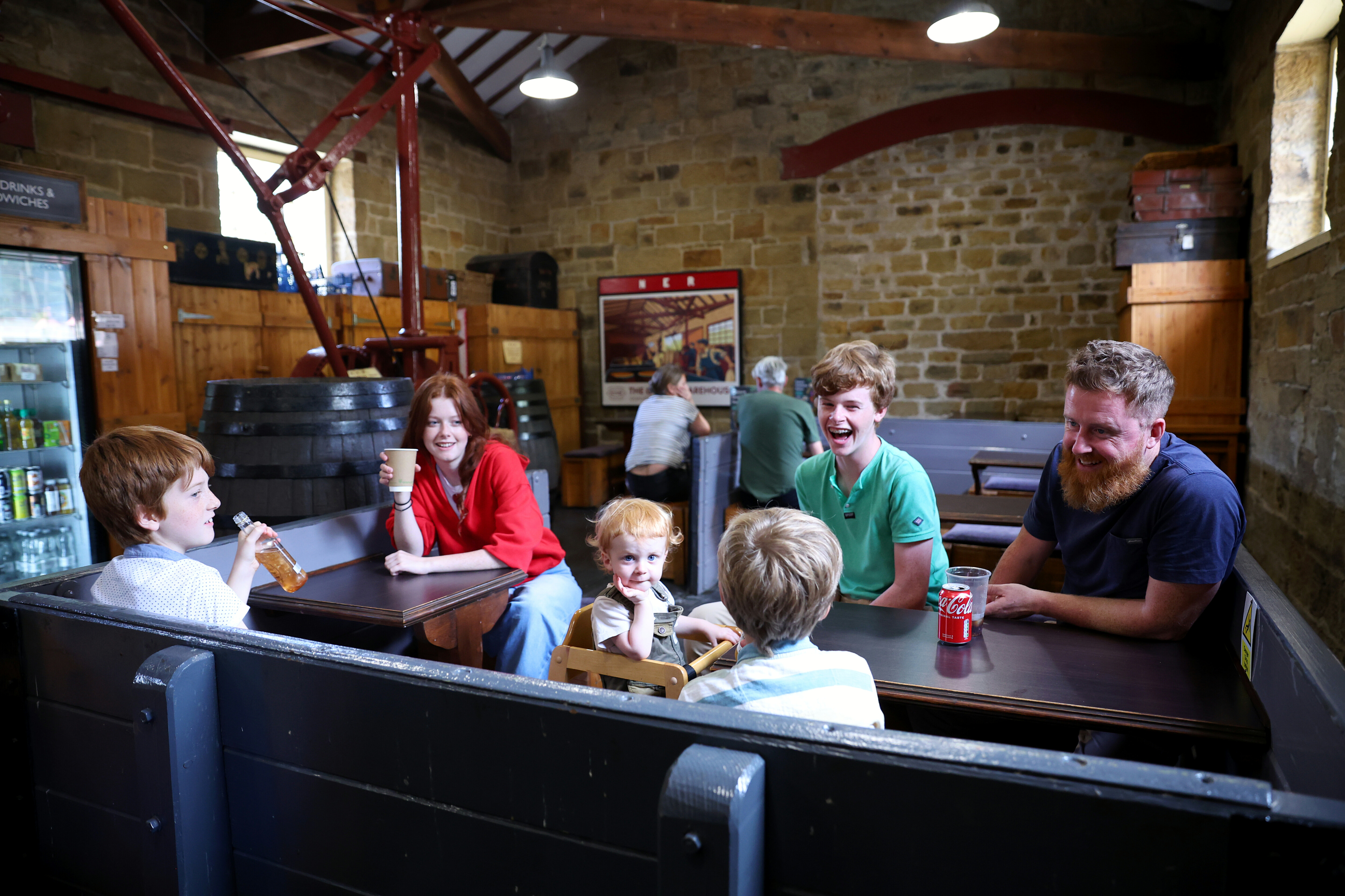 A family laugh and enjoy time in the Tea Room at Goathland.