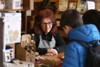 A shop assistant listens intently to a member of the public at Goathland Station shop.